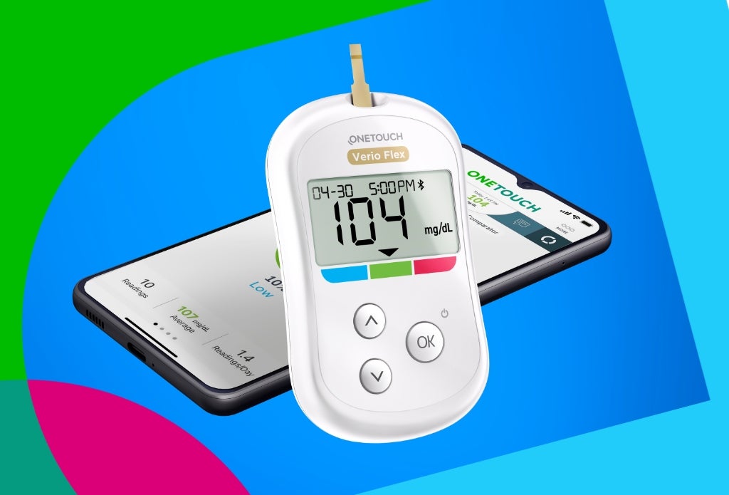 A OneTouch Verio Flex glucose meter displaying a reading of 104 mg/dL, positioned next to a smartphone showing health tracking information, against a colorful abstract background.