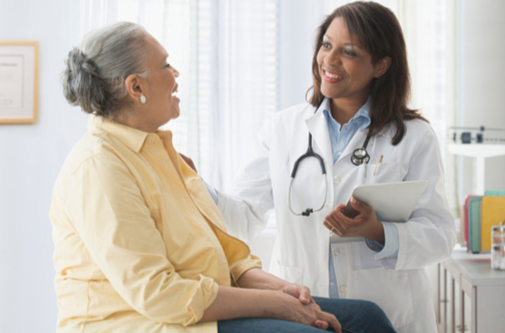 Doctor consulting with an elderly patient in a medical office.