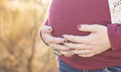 Woman holding stomach