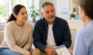 Healthcare provider reviewing a diabetes education brochure with a patient and his partner during a consultation.