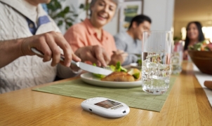 People enjoying a meal with Onetouch® meter next to them